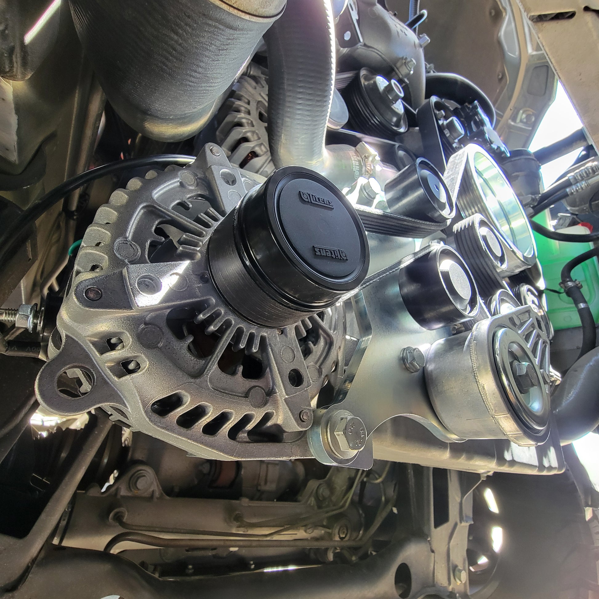 Dual alternator installed in Sprinter van engine bay, showing robust installation and integration with engine components